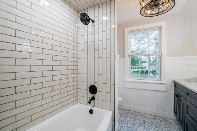 full bathroom with vanity, toilet, and tiled shower / bath combo