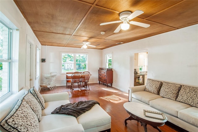 living area with a ceiling fan, wood finished floors, and wood ceiling