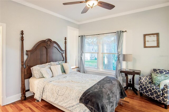bedroom with ceiling fan, baseboards, ornamental molding, and wood finished floors