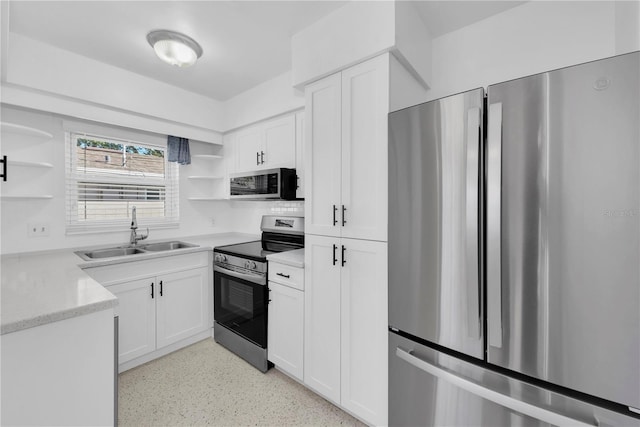 kitchen featuring white cabinetry, sink, and appliances with stainless steel finishes