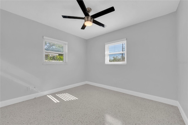 unfurnished room with a wealth of natural light and ceiling fan