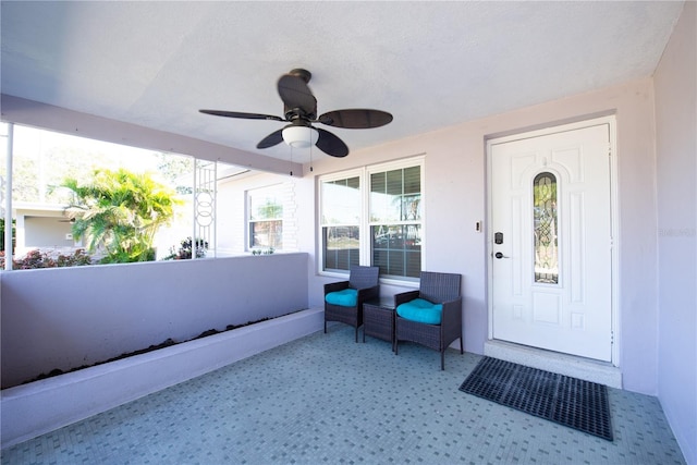 doorway to property with ceiling fan