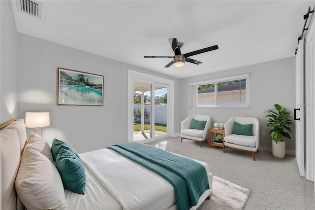 bedroom featuring ceiling fan, a barn door, and access to exterior