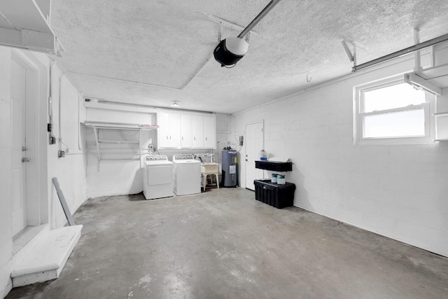 garage featuring washer and dryer, sink, a garage door opener, and water heater