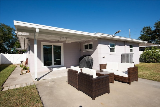 back of house featuring ceiling fan, a patio area, and an outdoor hangout area