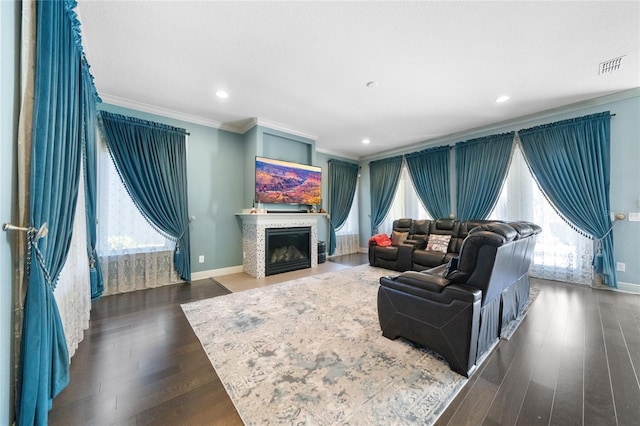 living room featuring crown molding, plenty of natural light, and dark hardwood / wood-style flooring