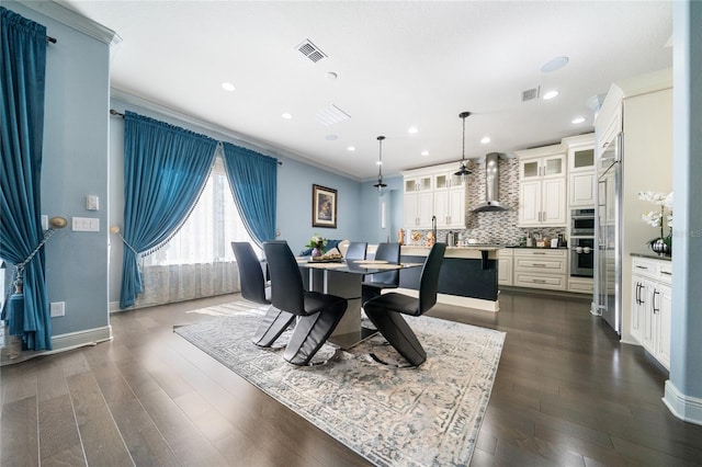 dining area with crown molding and dark hardwood / wood-style flooring