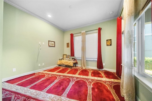 bedroom featuring multiple windows and crown molding