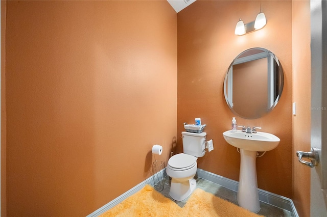 bathroom featuring tile patterned flooring, sink, and toilet