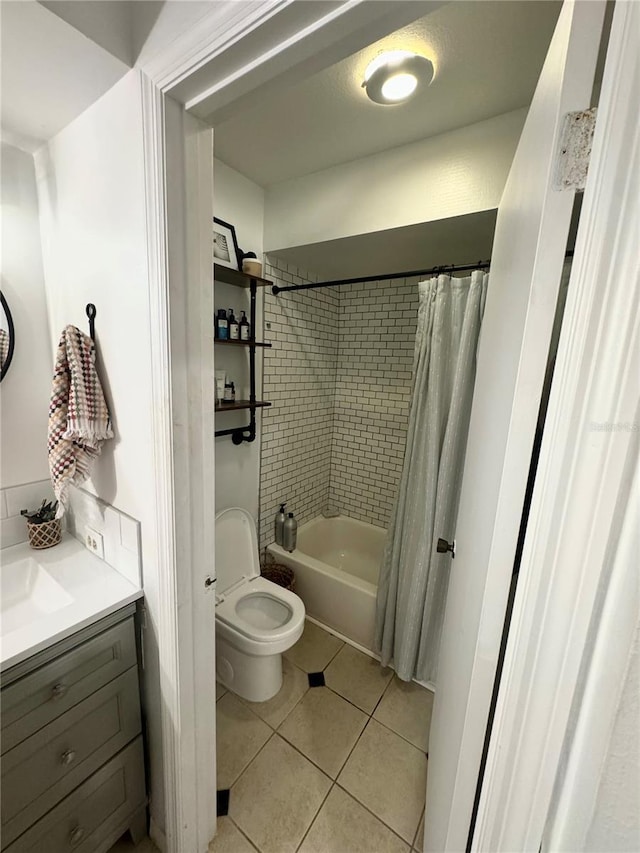 full bathroom featuring tile patterned floors, vanity, toilet, and shower / bathtub combination with curtain