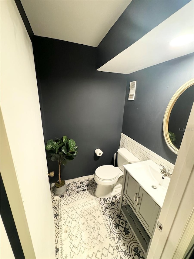 bathroom featuring toilet, vanity, and tile patterned floors