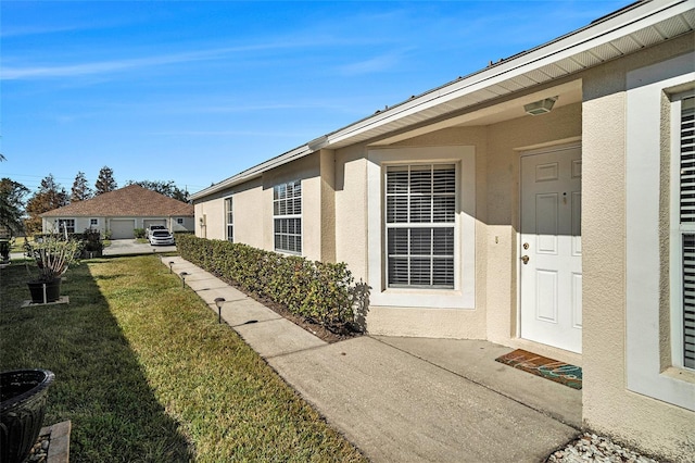 doorway to property featuring a yard