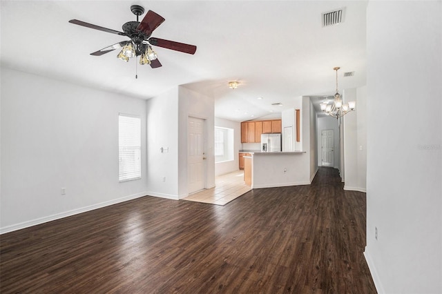 unfurnished living room with wood-type flooring and ceiling fan with notable chandelier