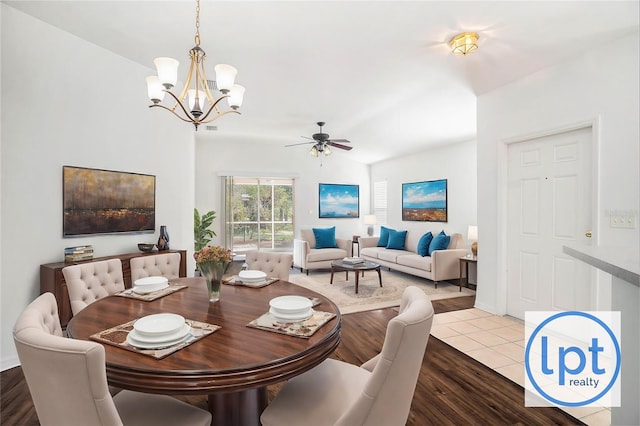 dining room featuring ceiling fan with notable chandelier and light wood-type flooring