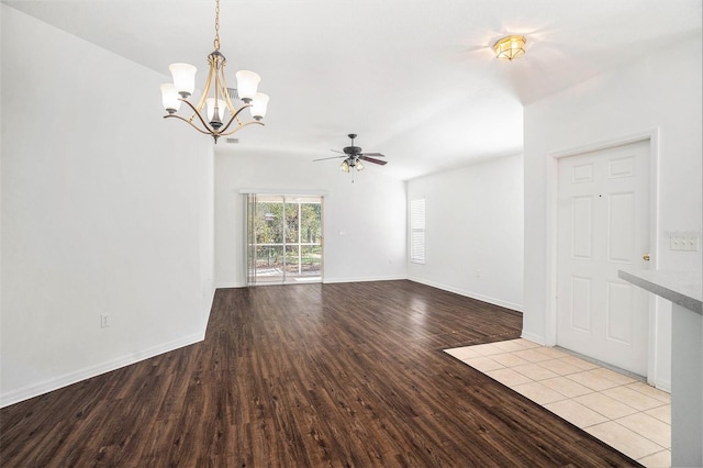 unfurnished living room featuring ceiling fan with notable chandelier and light hardwood / wood-style flooring