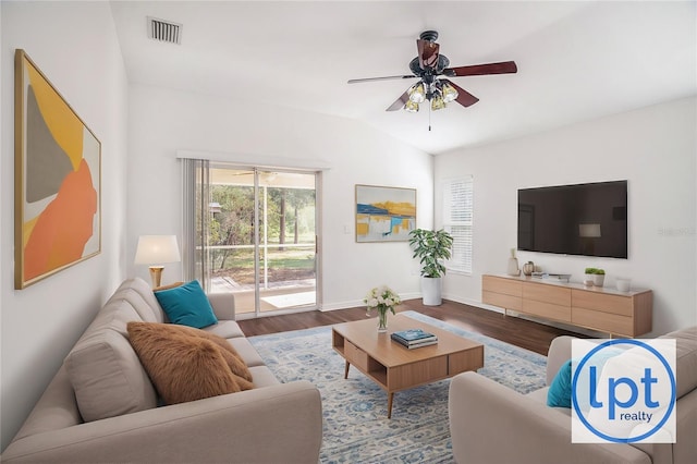 living room with ceiling fan, wood-type flooring, and vaulted ceiling