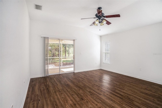 empty room with ceiling fan, dark wood-type flooring, and vaulted ceiling