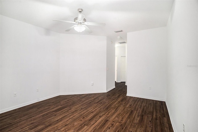 empty room featuring ceiling fan and dark hardwood / wood-style flooring