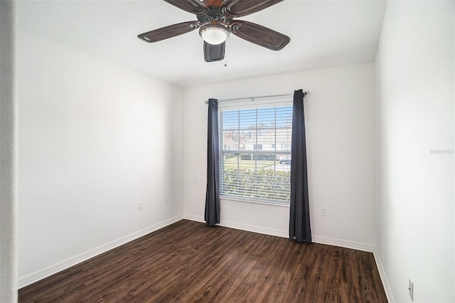 empty room with ceiling fan and dark hardwood / wood-style flooring