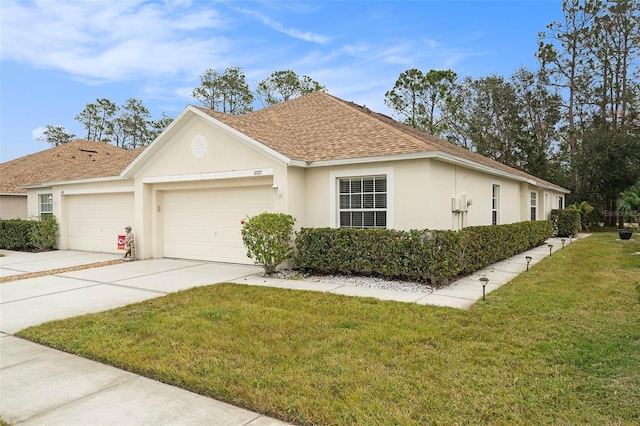 view of front of property with a garage and a front lawn