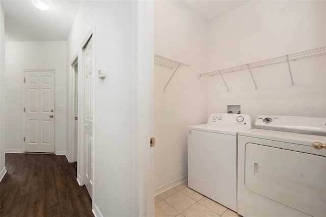 laundry room featuring hardwood / wood-style floors and separate washer and dryer