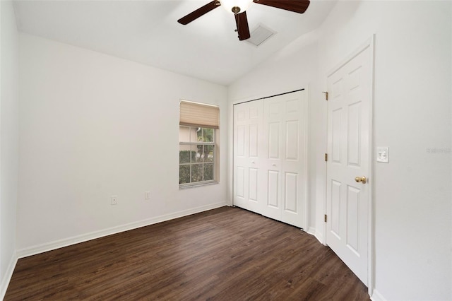 unfurnished bedroom featuring ceiling fan, a closet, dark wood-type flooring, and lofted ceiling