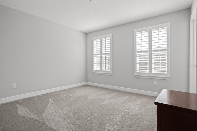 unfurnished room with carpet and a healthy amount of sunlight