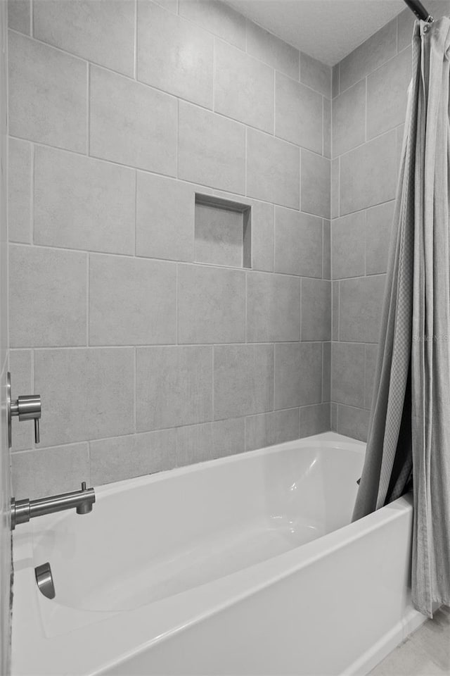 bathroom featuring shower / bathtub combination with curtain