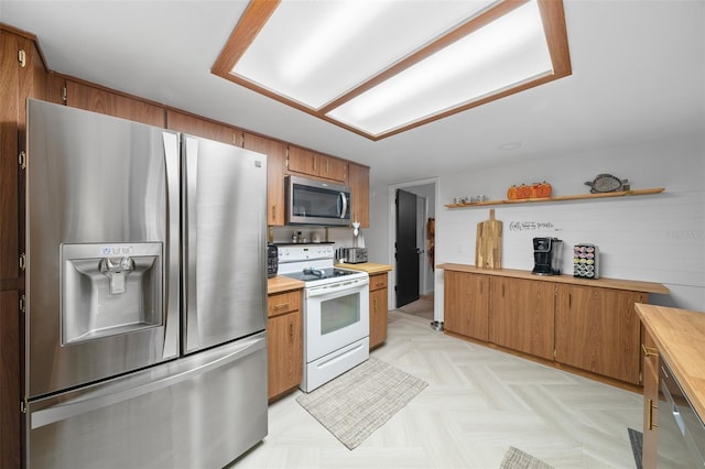 kitchen featuring light parquet flooring and appliances with stainless steel finishes