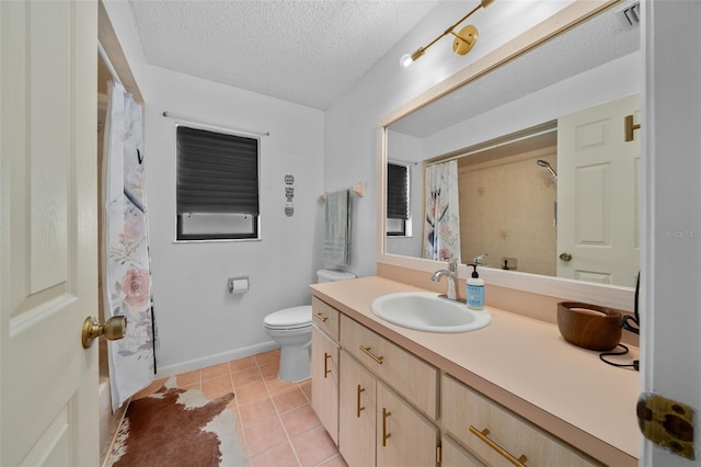 bathroom featuring tile patterned flooring, vanity, a textured ceiling, and toilet