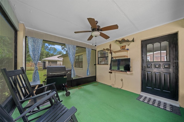 sunroom / solarium featuring ceiling fan