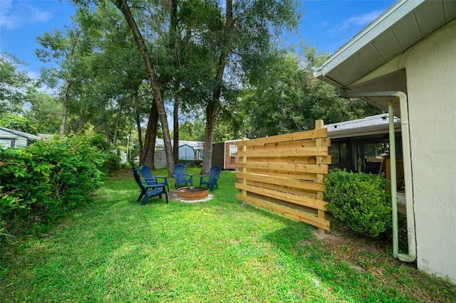 view of yard with an outdoor fire pit