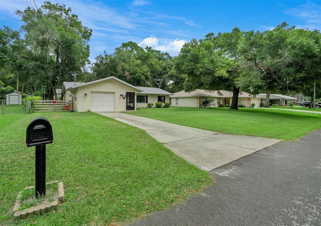 single story home featuring a garage and a front lawn