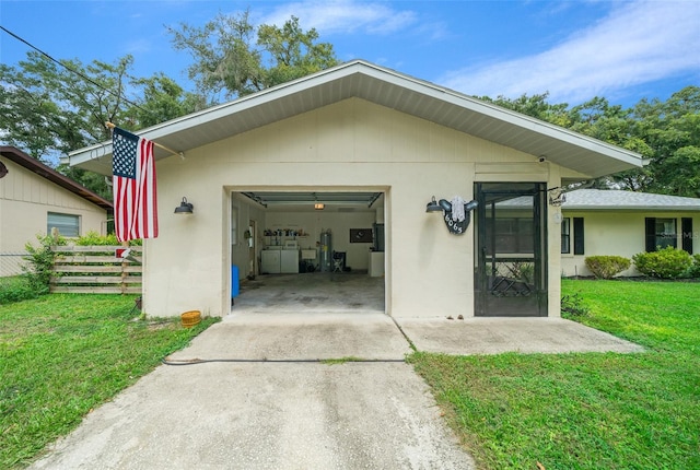 garage featuring a lawn and washing machine and dryer