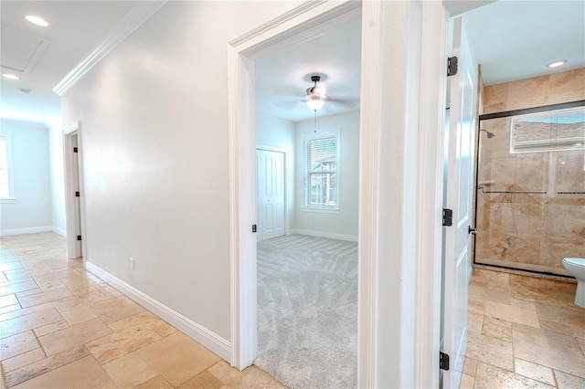 hall with light carpet and ornamental molding