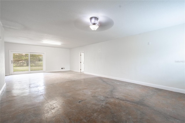 empty room with ceiling fan and a textured ceiling