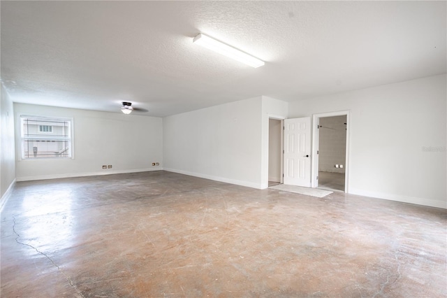 unfurnished room featuring ceiling fan, concrete flooring, and a textured ceiling