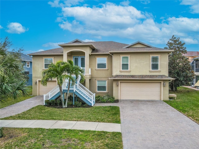 view of front of property with a front lawn and a garage