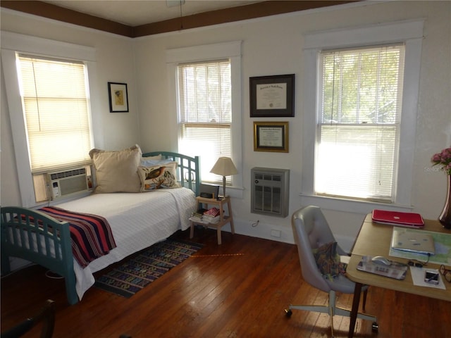 bedroom featuring heating unit, dark hardwood / wood-style floors, multiple windows, and cooling unit