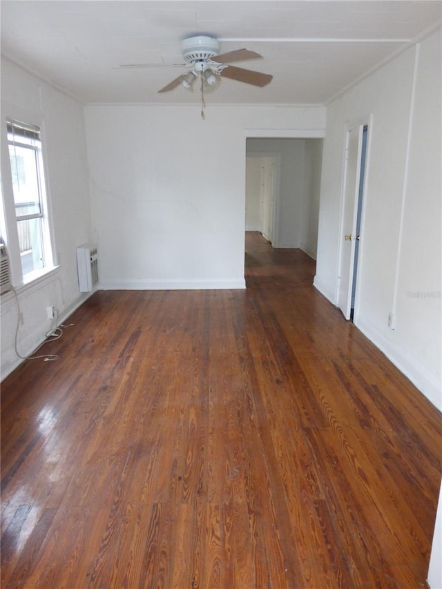 empty room featuring ceiling fan and dark hardwood / wood-style flooring