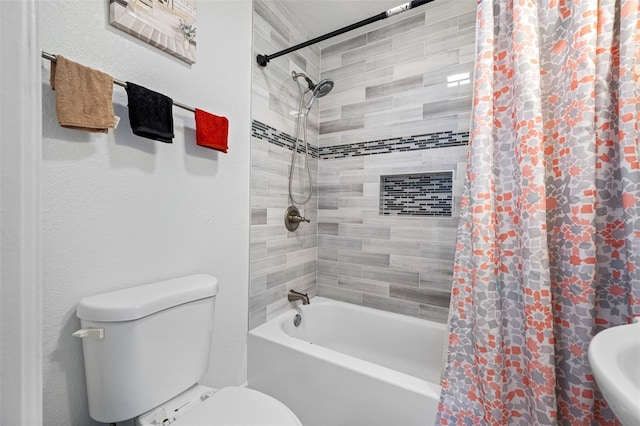 full bathroom featuring shower / bath combination with curtain, toilet, and sink