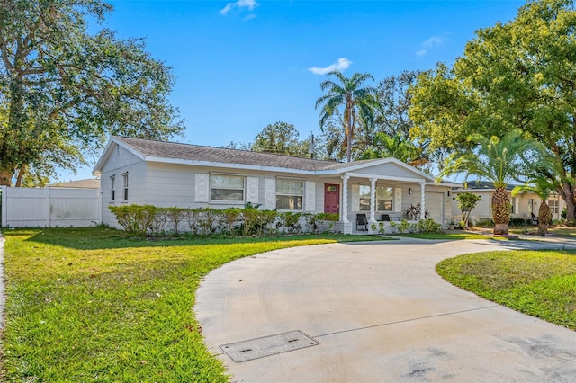 ranch-style house with a porch and a front lawn