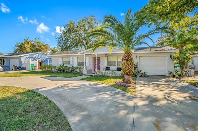 ranch-style house featuring a garage and a front yard