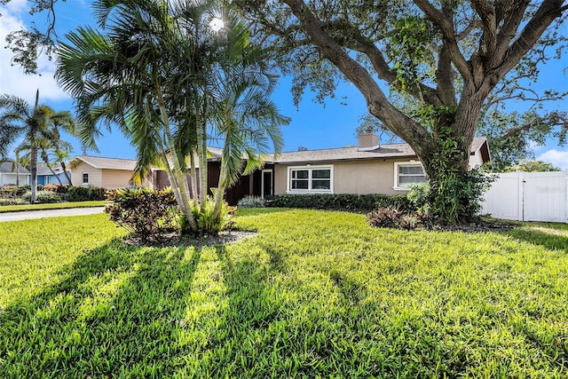 ranch-style home with a front yard