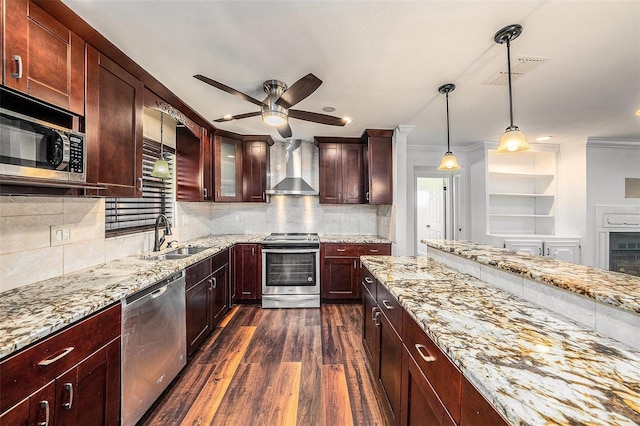 kitchen featuring appliances with stainless steel finishes, dark hardwood / wood-style flooring, wall chimney exhaust hood, sink, and pendant lighting