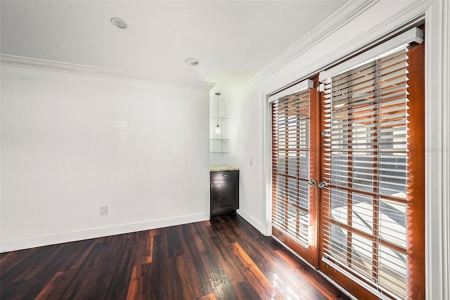 empty room featuring crown molding and dark wood-type flooring