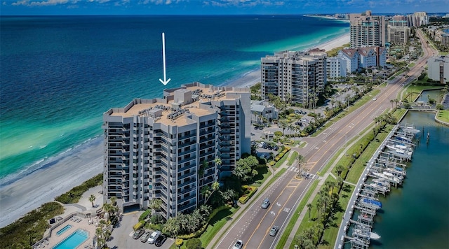 aerial view with a water view and a beach view