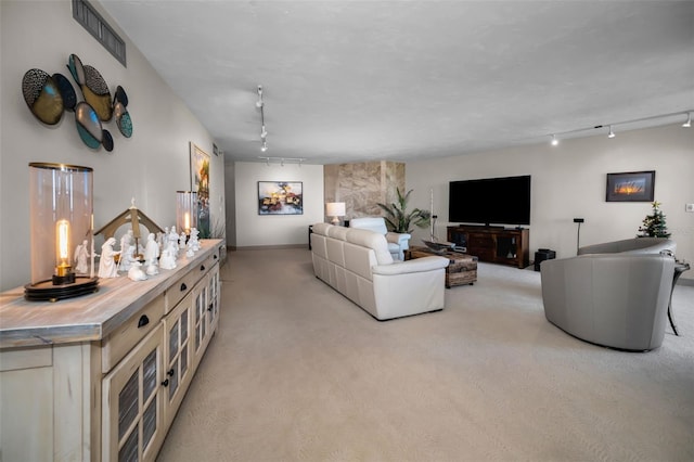 living room featuring light carpet and rail lighting