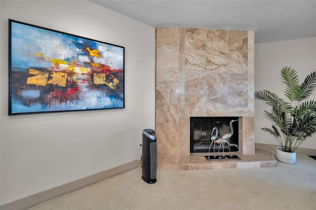 interior details featuring carpet flooring and a tiled fireplace