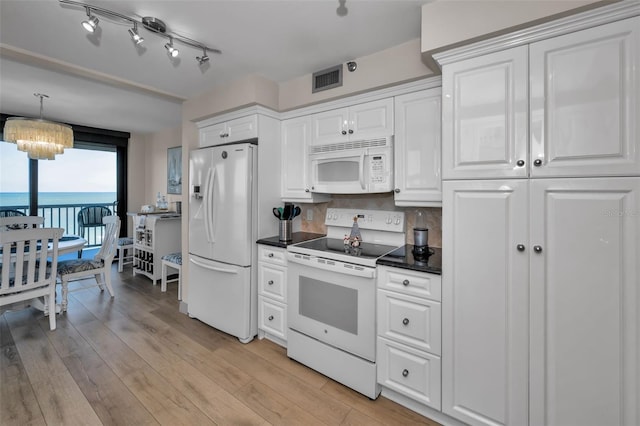 kitchen featuring white cabinetry, white appliances, decorative backsplash, a water view, and light wood-type flooring